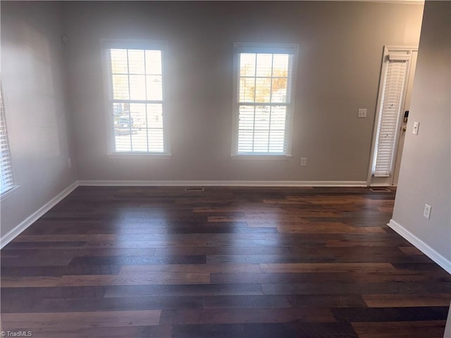 unfurnished room featuring dark wood-type flooring