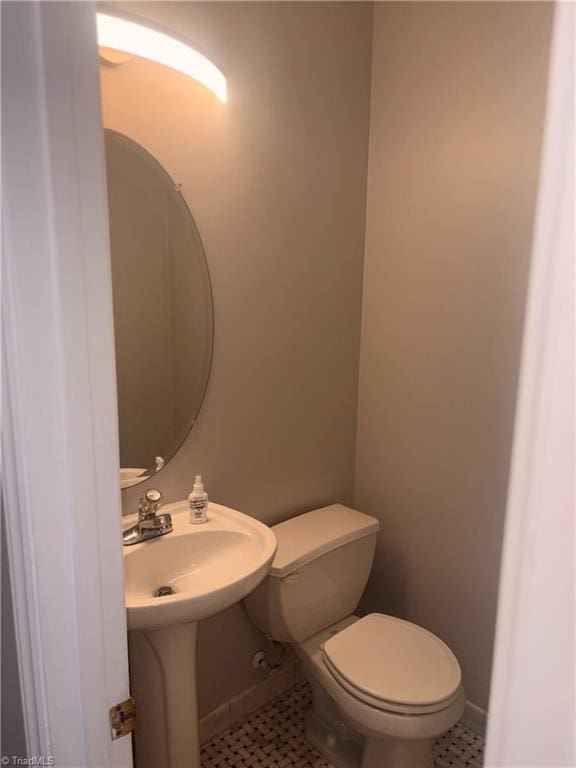 bathroom with tile patterned flooring and toilet