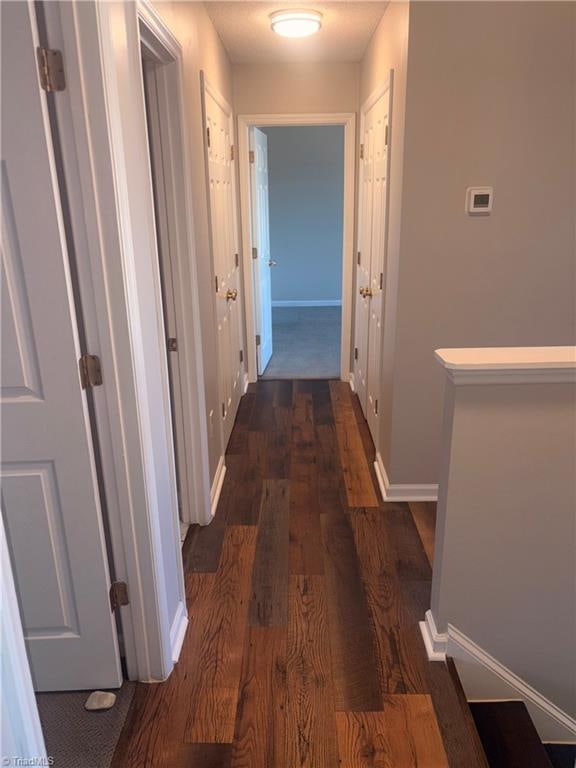 hall with dark wood-type flooring