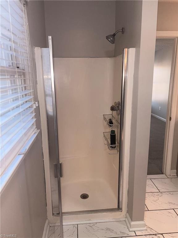 bathroom with a shower with shower door