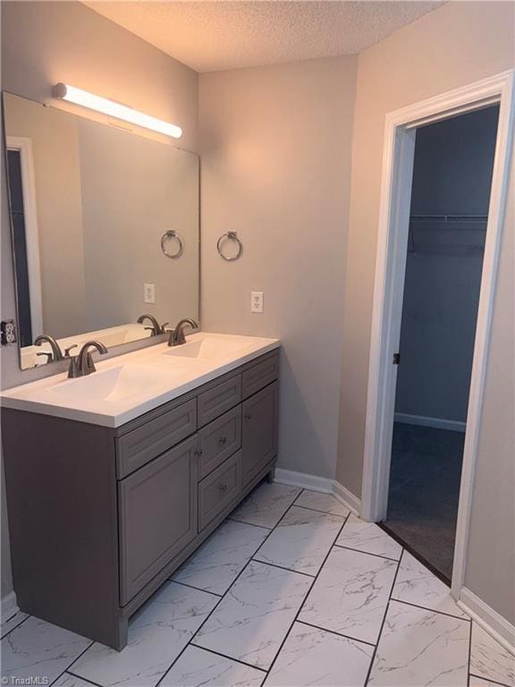 bathroom with vanity and a textured ceiling