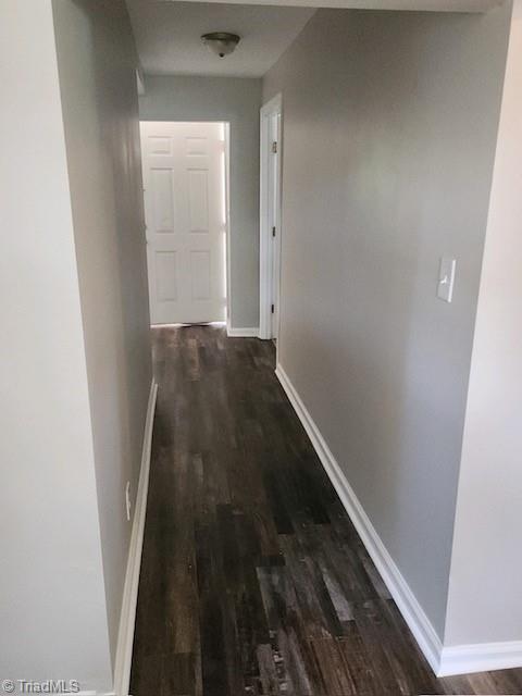 hall with dark wood-type flooring