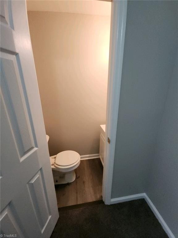 bathroom featuring hardwood / wood-style floors, vanity, and toilet