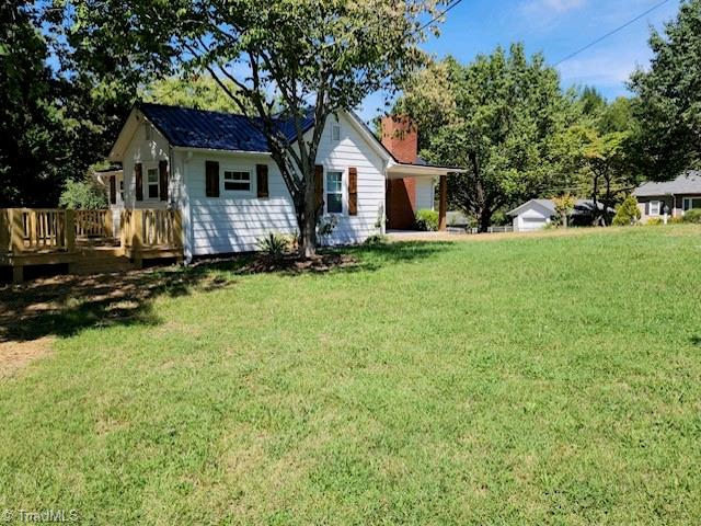 exterior space with a front yard and a deck