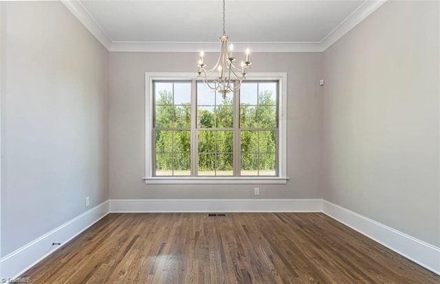 unfurnished dining area featuring crown molding, a healthy amount of sunlight, dark wood-type flooring, and an inviting chandelier