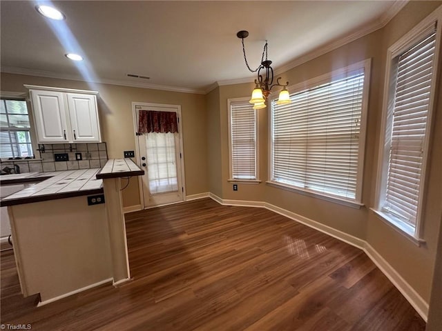 4727 Eagle Path, Winston-Salem, NC 27127 - kitchen with tile countertops, dark wood finished floors, white cabinets, ornamental molding, and hanging light fixtures