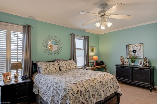 carpeted bedroom featuring ornamental molding and a ceiling fan