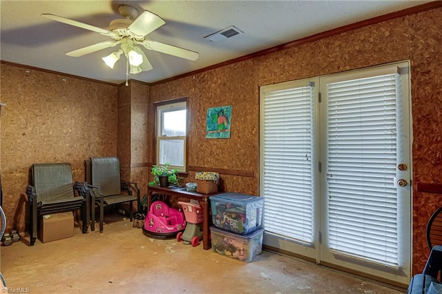 interior space featuring visible vents, wallpapered walls, unfinished concrete flooring, crown molding, and a ceiling fan