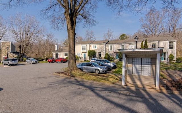 view of front of property with a residential view and uncovered parking