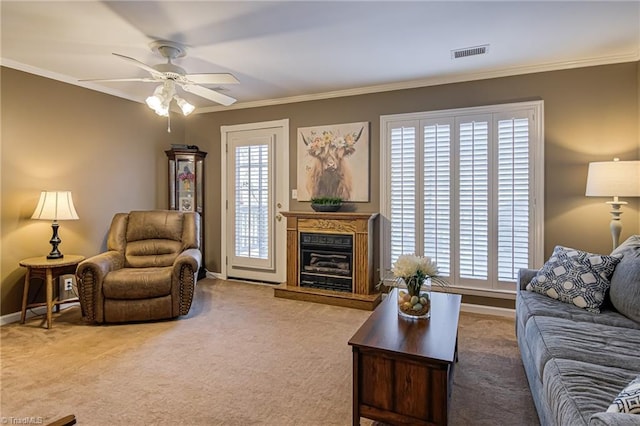 living room featuring crown molding, plenty of natural light, visible vents, and carpet floors