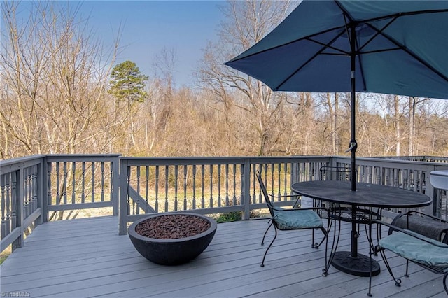 wooden terrace with outdoor dining area