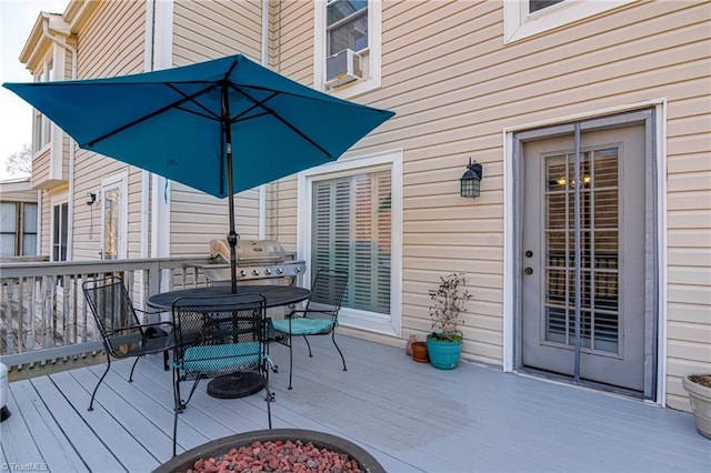 wooden terrace with area for grilling, cooling unit, and outdoor dining area