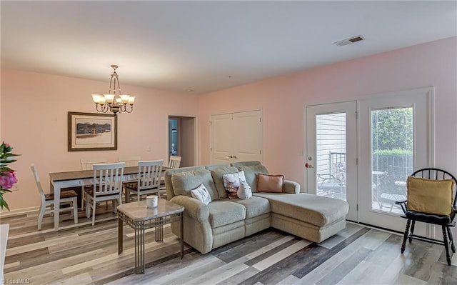 6801 Hanesbrook Cir Unit 104, Clemmons, NC 27012 - living room with a chandelier and light wood-style floors