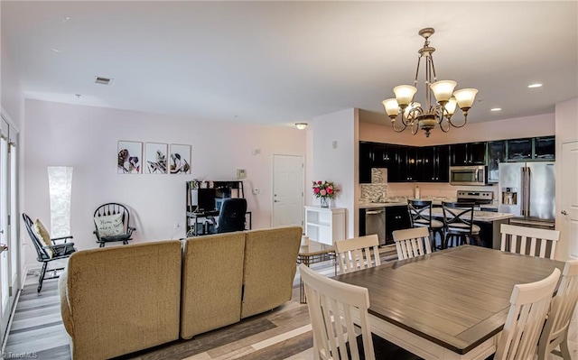 6801 Hanesbrook Cir Unit 104, Clemmons, NC 27012 - dining space featuring light wood-type flooring, a chandelier, and recessed lighting