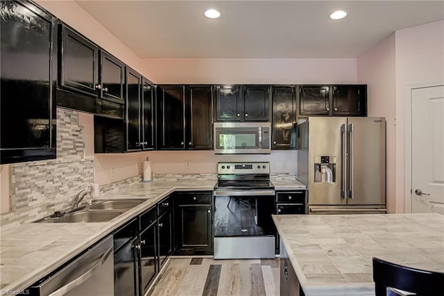 6801 Hanesbrook Cir Unit 104, Clemmons, NC 27012 - kitchen featuring stainless steel appliances, a sink, dark cabinetry, tile countertops, and recessed lighting