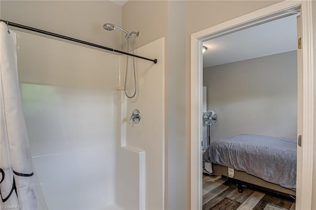 6801 Hanesbrook Cir Unit 104, Clemmons, NC 27012 - bathroom with curtained shower and wood finished floors