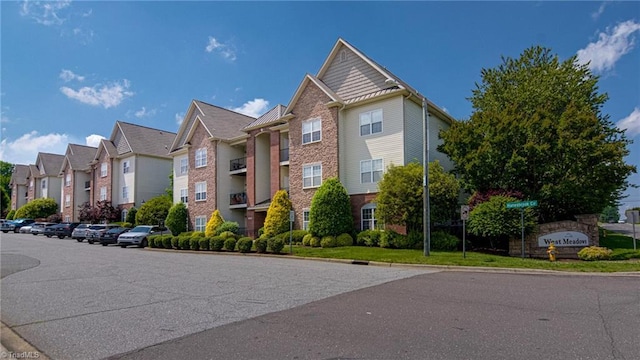 6801 Hanesbrook Cir Unit 104, Clemmons, NC 27012 - view of building exterior featuring a residential view and uncovered parking