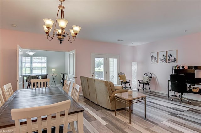 6801 Hanesbrook Cir Unit 104, Clemmons, NC 27012 - dining area featuring a chandelier and light wood-style flooring