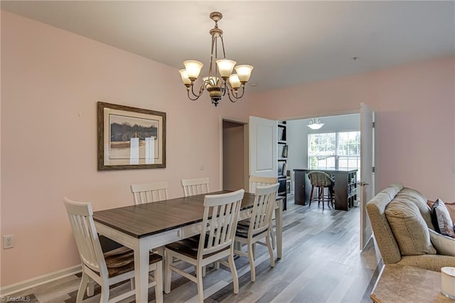 6801 Hanesbrook Cir Unit 104, Clemmons, NC 27012 - dining space with a chandelier, light wood-style flooring, and baseboards