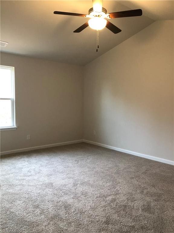 2866 Tysinger Rd, Denton, NC 27239 - unfurnished room featuring lofted ceiling, a ceiling fan, carpet flooring, and baseboards