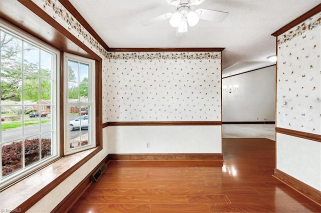 206 Swaim Ct, Salisbury, NC 28147 - empty room with baseboards, wallpapered walls, wood finished floors, ornamental molding, and ceiling fan