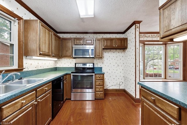 206 Swaim Ct, Salisbury, NC 28147 - kitchen with stainless steel appliances, a sink, a textured ceiling, wallpapered walls, and dark wood-style floors