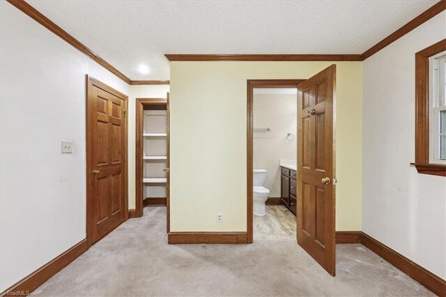 206 Swaim Ct, Salisbury, NC 28147 - unfurnished bedroom with ornamental molding, light carpet, baseboards, connected bathroom, and a textured ceiling