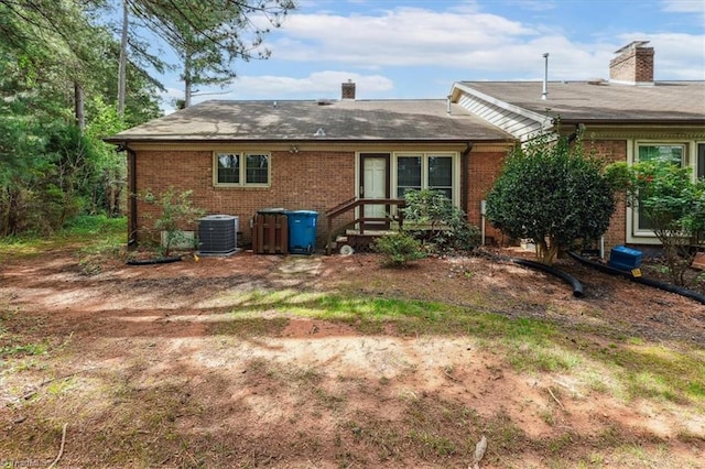 206 Swaim Ct, Salisbury, NC 28147 - back of property featuring a chimney, brick siding, and cooling unit