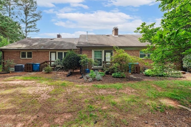 206 Swaim Ct, Salisbury, NC 28147 - rear view of house featuring brick siding, central air condition unit, a chimney, and a yard