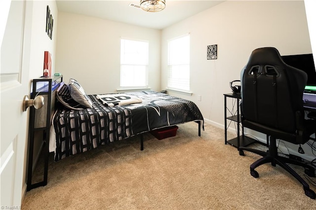 bedroom featuring carpet floors and baseboards