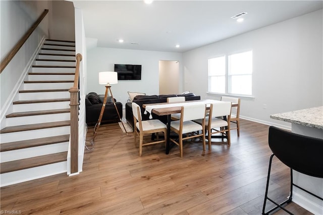 dining space with visible vents, recessed lighting, stairway, light wood-style flooring, and baseboards