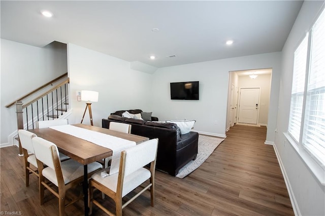 dining area featuring recessed lighting, dark wood-type flooring, baseboards, and stairs