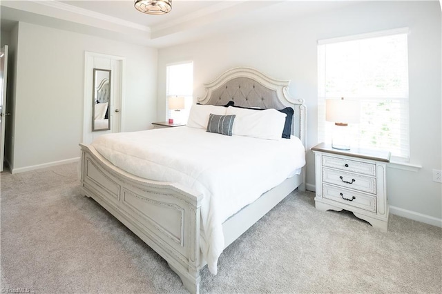 bedroom with ornamental molding, multiple windows, light carpet, and baseboards