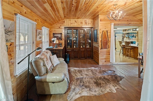 living room with wood walls, hardwood / wood-style floors, wood ceiling, and lofted ceiling