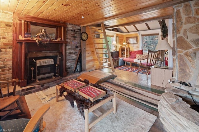 living room with wood walls, a wood stove, wooden ceiling, lofted ceiling with beams, and hardwood / wood-style flooring