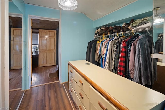 walk in closet featuring dark wood-type flooring and lofted ceiling