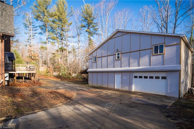 view of home's exterior featuring a garage and a wooden deck