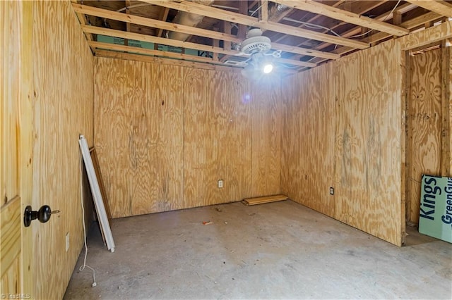 basement featuring wood walls