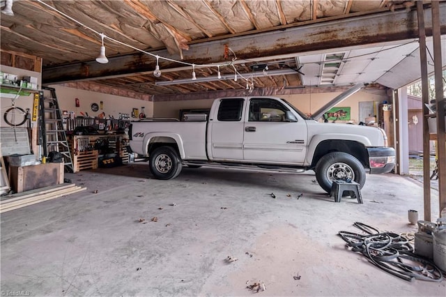 garage with a workshop area and a carport