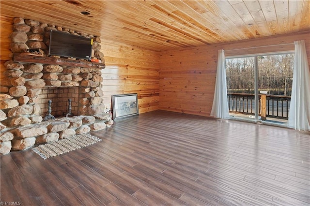 unfurnished living room with a fireplace, wooden walls, hardwood / wood-style flooring, and wooden ceiling