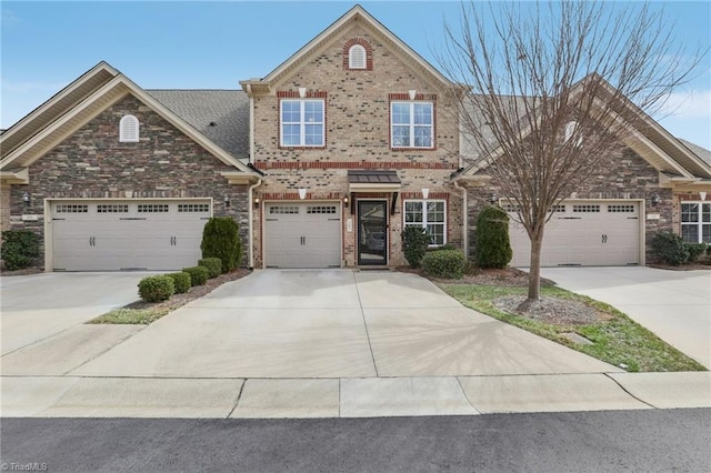 traditional-style home with brick siding, driveway, and a garage