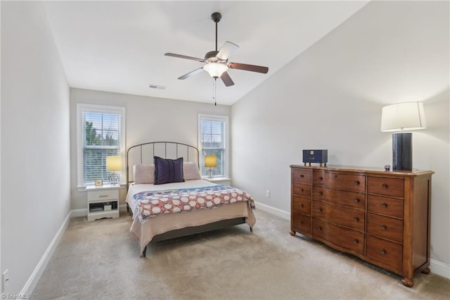 bedroom featuring lofted ceiling, light colored carpet, and baseboards