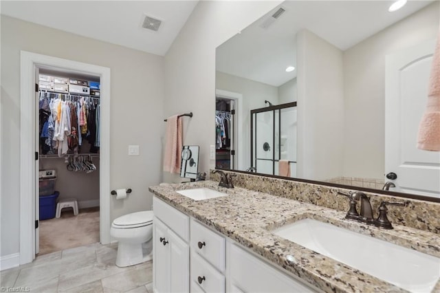 full bathroom featuring visible vents, a shower stall, toilet, and a sink