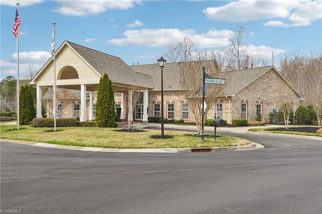 view of front of property with a front yard and brick siding