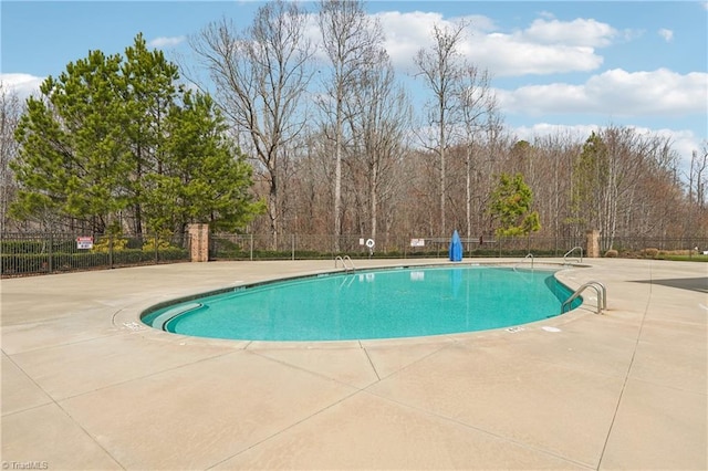 pool featuring a patio and fence