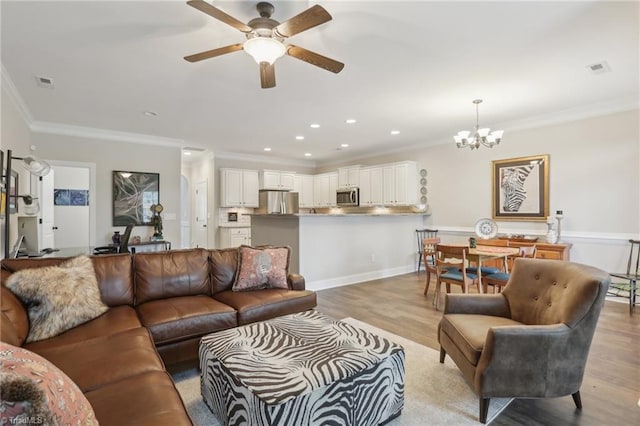 living area featuring visible vents, light wood-style flooring, ceiling fan with notable chandelier, recessed lighting, and crown molding