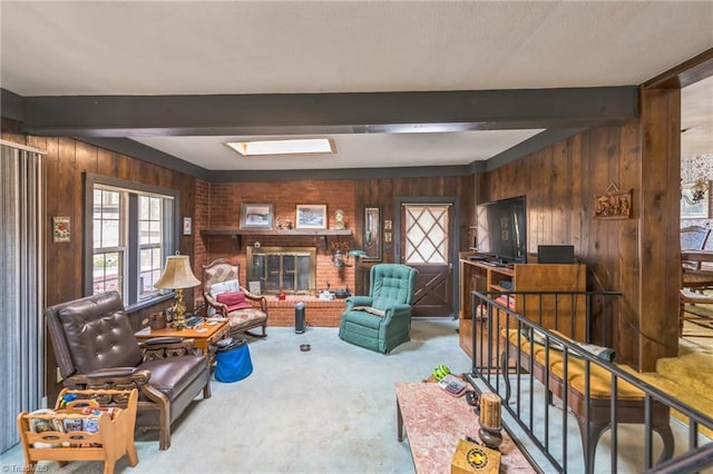 interior space with beam ceiling, a fireplace, wood walls, and carpet floors