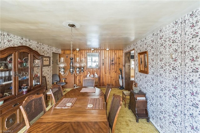 unfurnished dining area featuring carpet and a notable chandelier