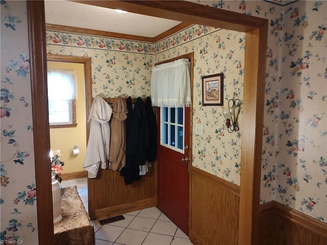 345 Anderson Rd, Eden, NC 27288 - entryway with light tile patterned floors, a wainscoted wall, and wallpapered walls
