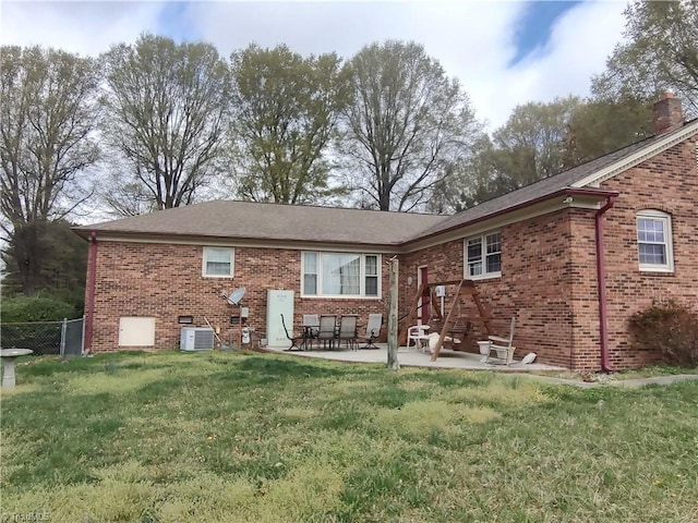 345 Anderson Rd, Eden, NC 27288 - back of property with a patio, brick siding, fence, and a lawn